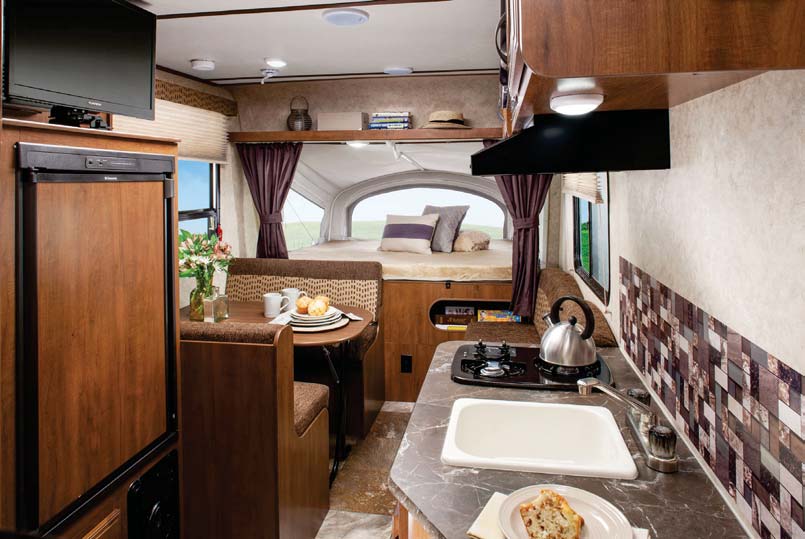 Hybrid travel trailers like the Jay Feather 16XRB have beds that extend from the front and back walls to expand your interior living space.