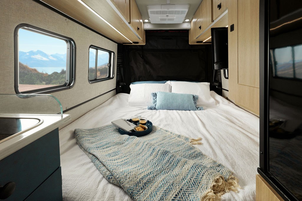 Roadtrek Play + interior, showing rear master bedroom sleeping accommodations.