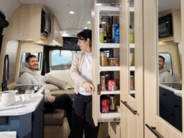 Roadtrek 2025 Play + model interior showing galley pantry and rear lounge in dinette mode.