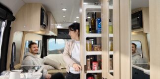 Roadtrek 2025 Play + model interior showing galley pantry and rear lounge in dinette mode.