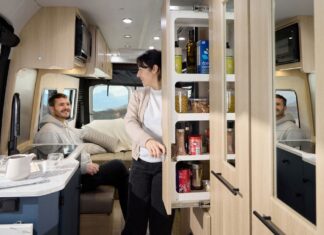 Roadtrek 2025 Play + model interior showing galley pantry and rear lounge in dinette mode.